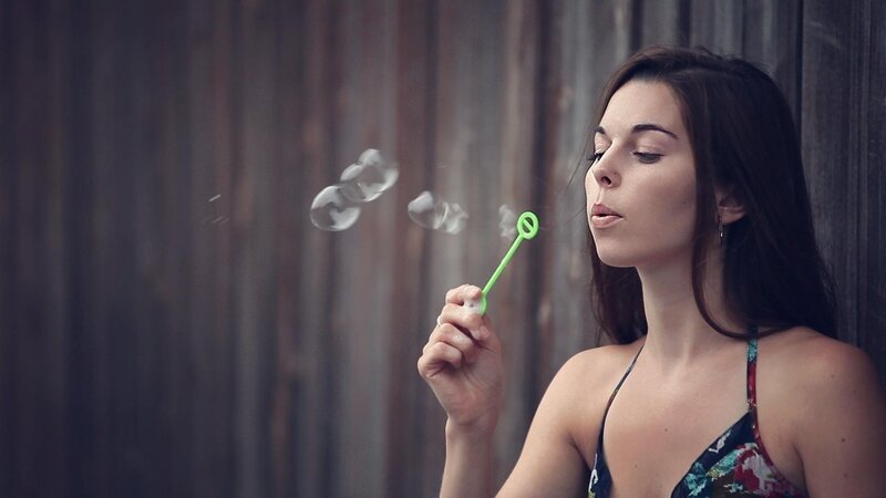 Woman Blowing Bubbles — Brown, Calm