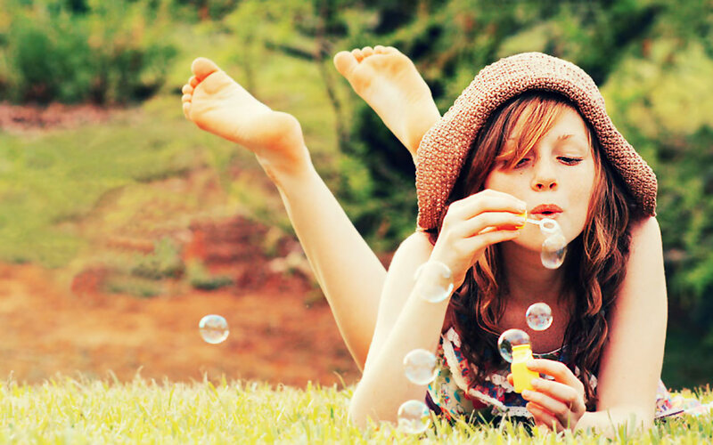 Woman Blowing Bubbles — Green, Playful, Afternoon, Photograph, Hat, Grass