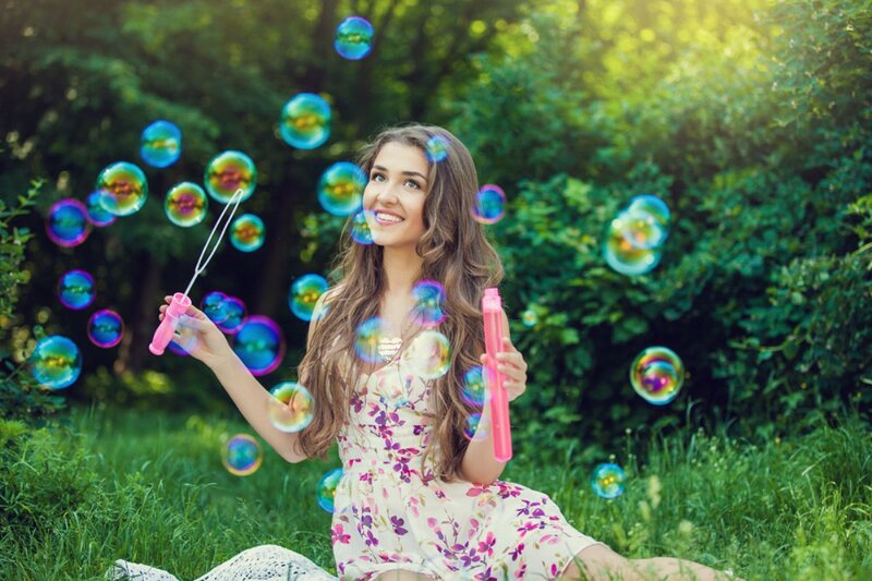 Woman Blowing Bubbles — Green, Playful, Afternoon
