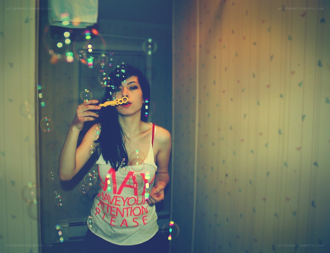 woman blowing bubbles in mirror