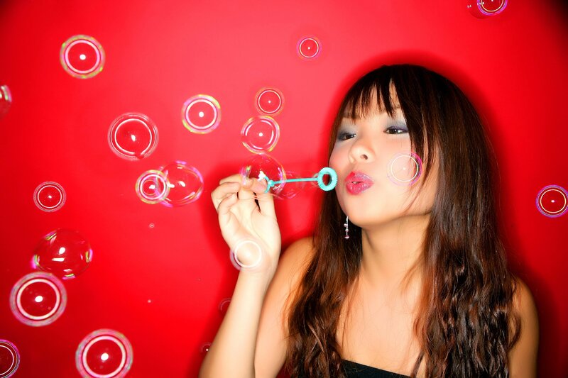 Woman Blowing Bubbles — Red, Playful