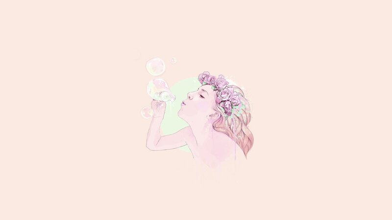 woman blowing bubbles with flower crown