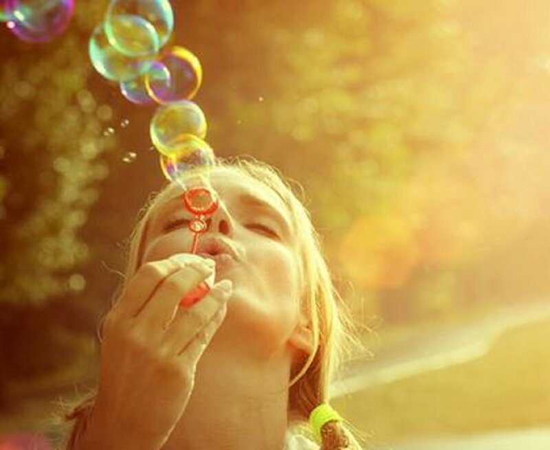 Woman Blowing Bubbles — Yellow, Serene, Sunset