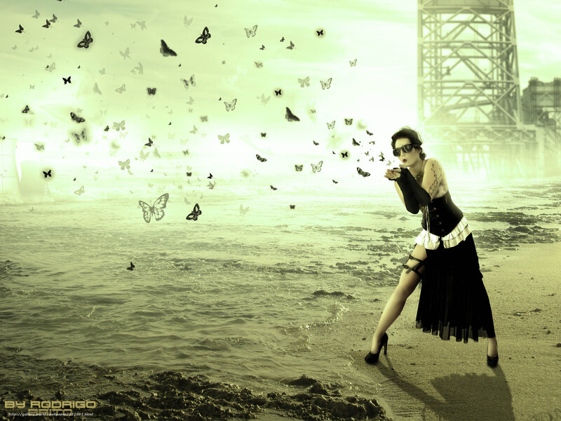 woman blowing butterflies on beach