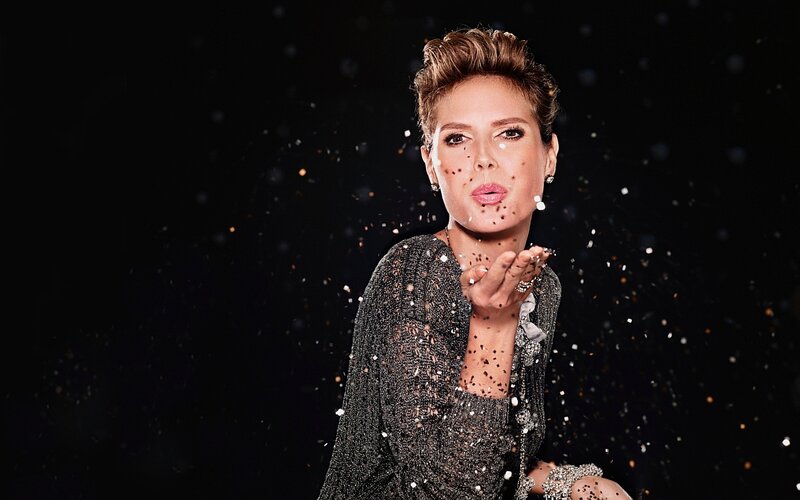 Woman Blowing Confetti — Black, Celebratory