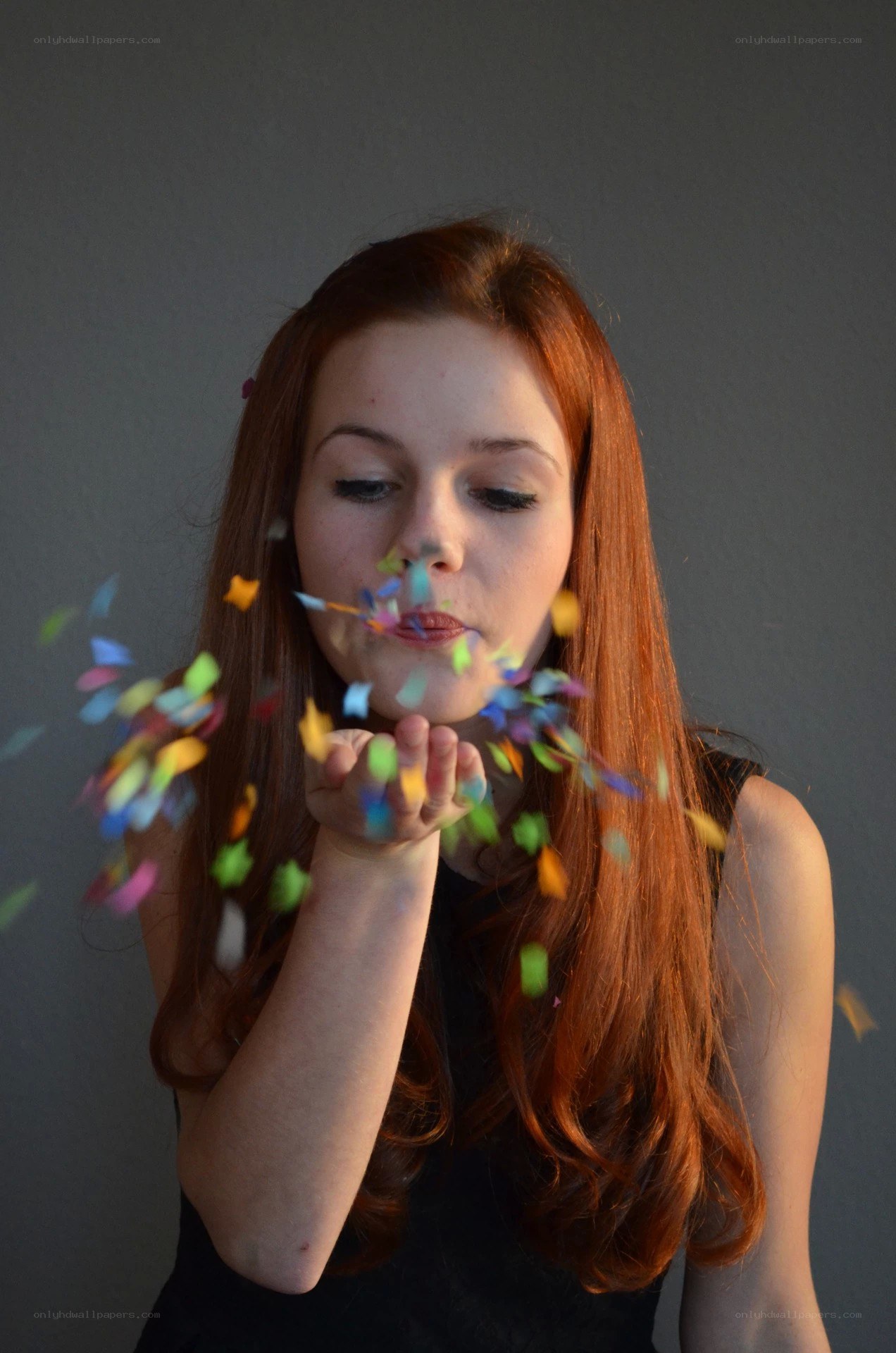 woman blowing confetti