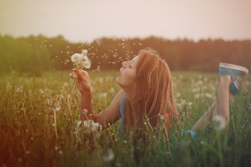 Woman Blowing Dandelion — Green, Serene, Sunset