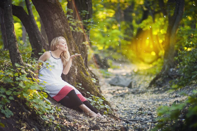 Woman Blowing Dandelion Seeds — Green, Serene, Afternoon