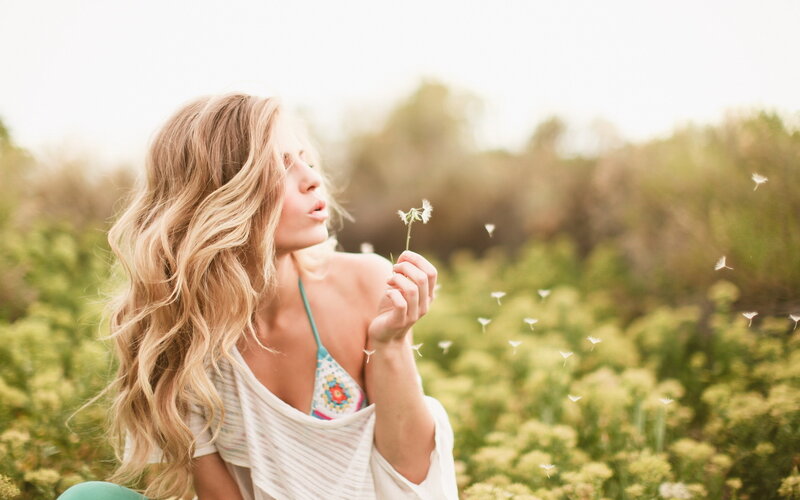Woman Blowing Dandelion Seeds — Green