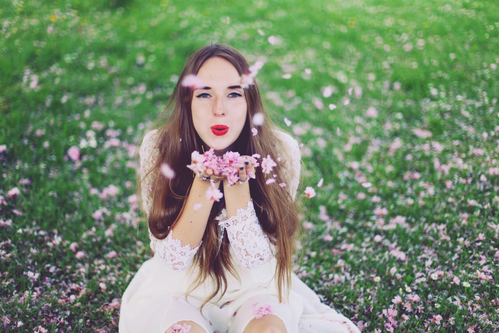 woman blowing flower petals