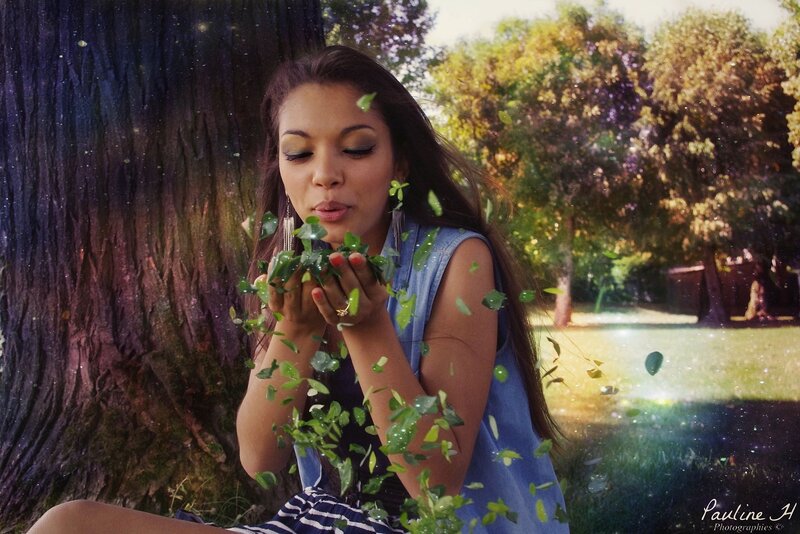 woman blowing leaves in park