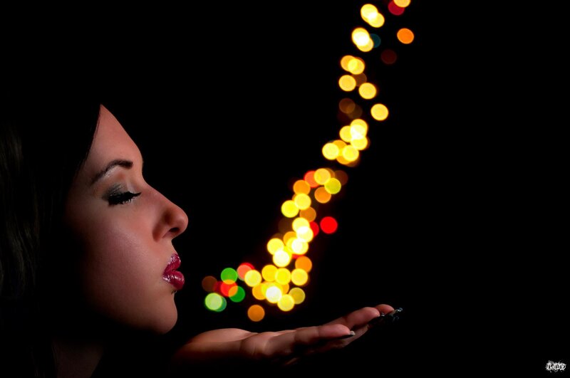 woman blowing lights in profile