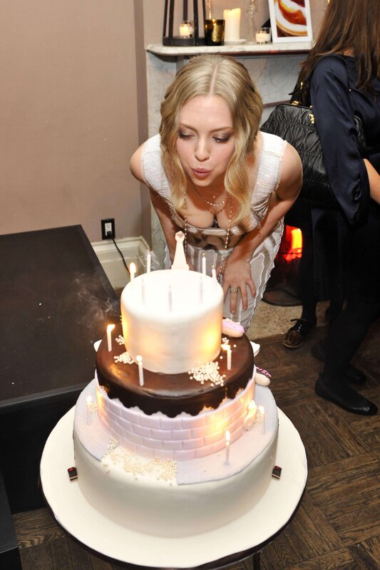 Woman blowing out birthday candles