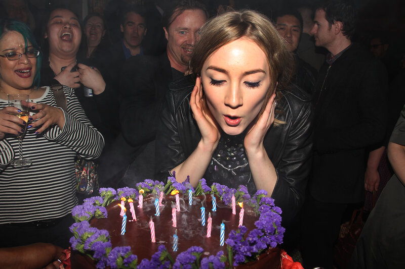 Woman blowing out birthday candles