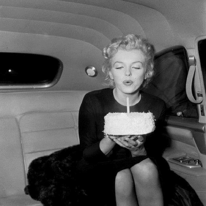 Woman Blowing Out Candle