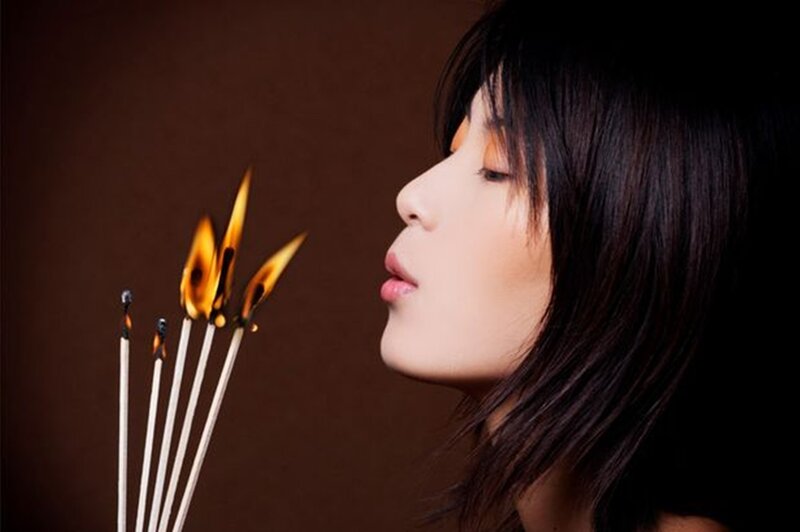 Woman Blowing Out Matches