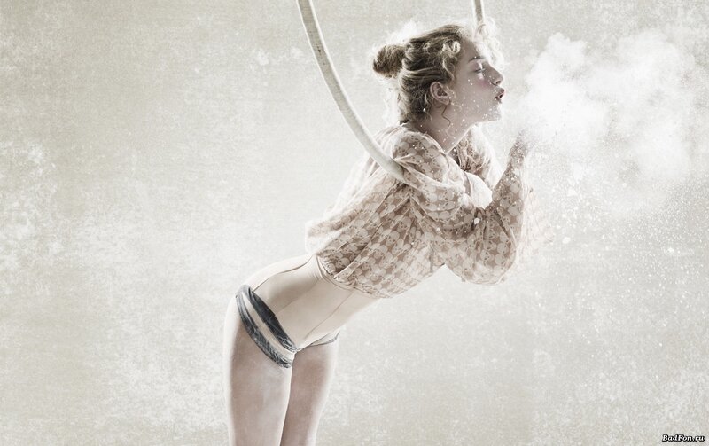 woman blowing powder in studio