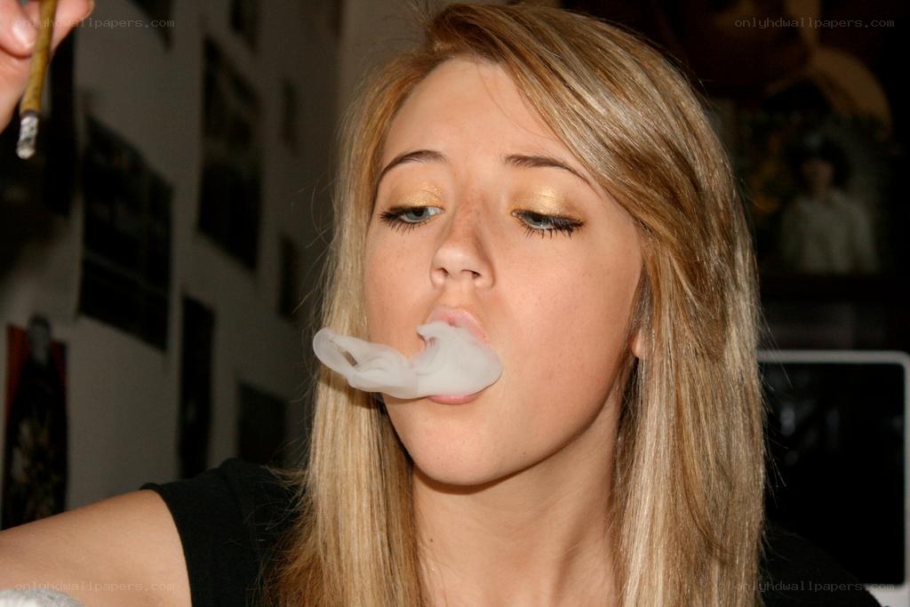 woman blowing smoke ring