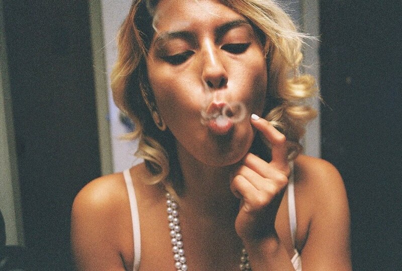 woman blowing smoke rings