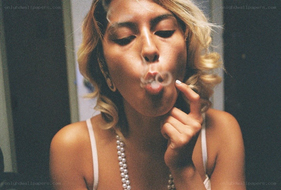 woman blowing smoke rings
