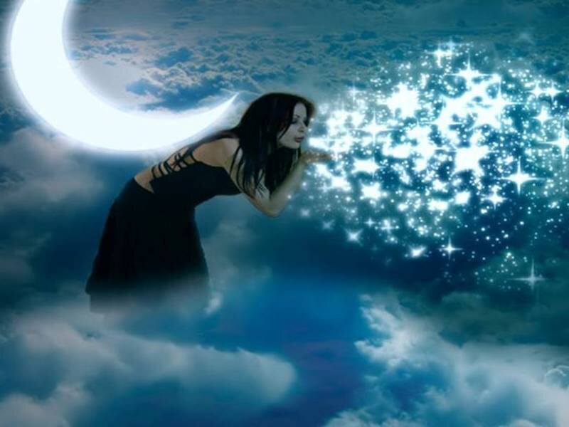 woman blowing stars under moon