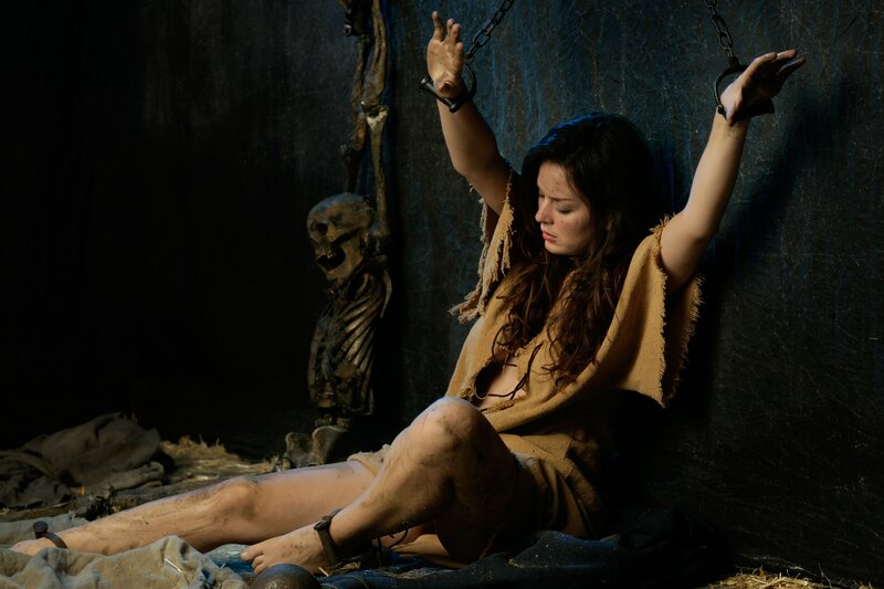 woman bound in dungeon