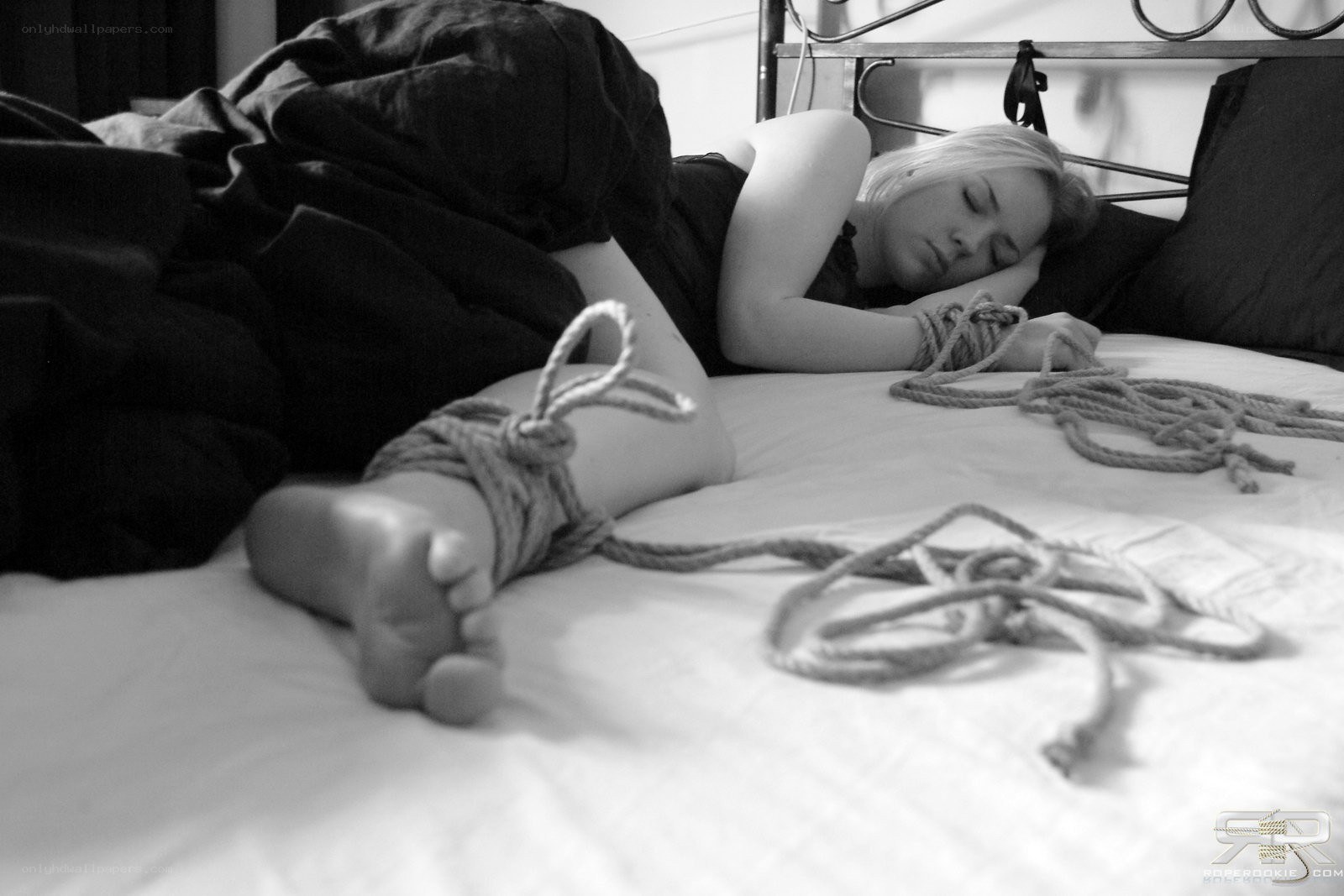 Woman bound on a bed