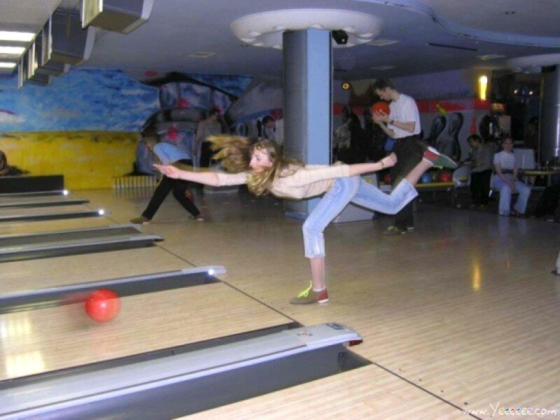 Woman bowling at a lane