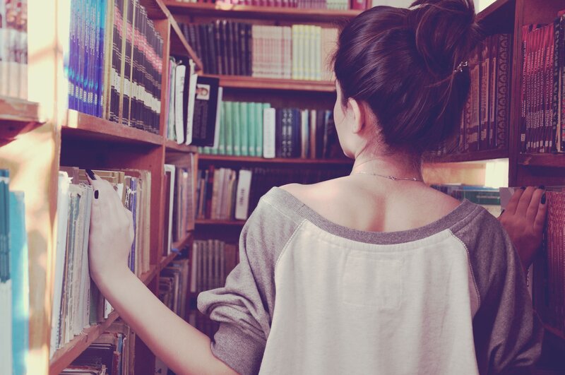 woman browsing books in library