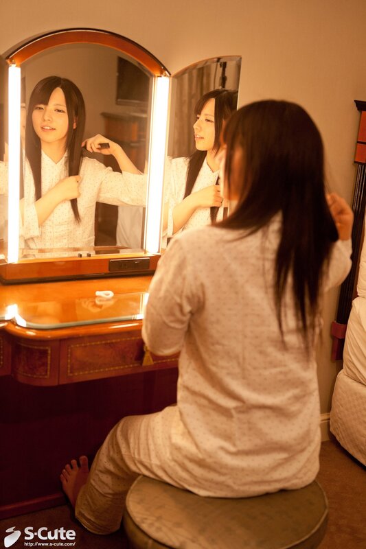 woman brushing hair at vanity