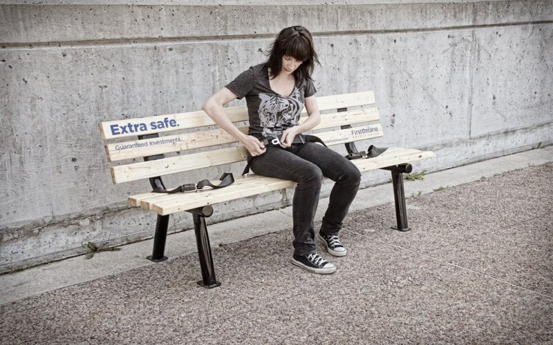 Woman buckling seatbelt on bench
