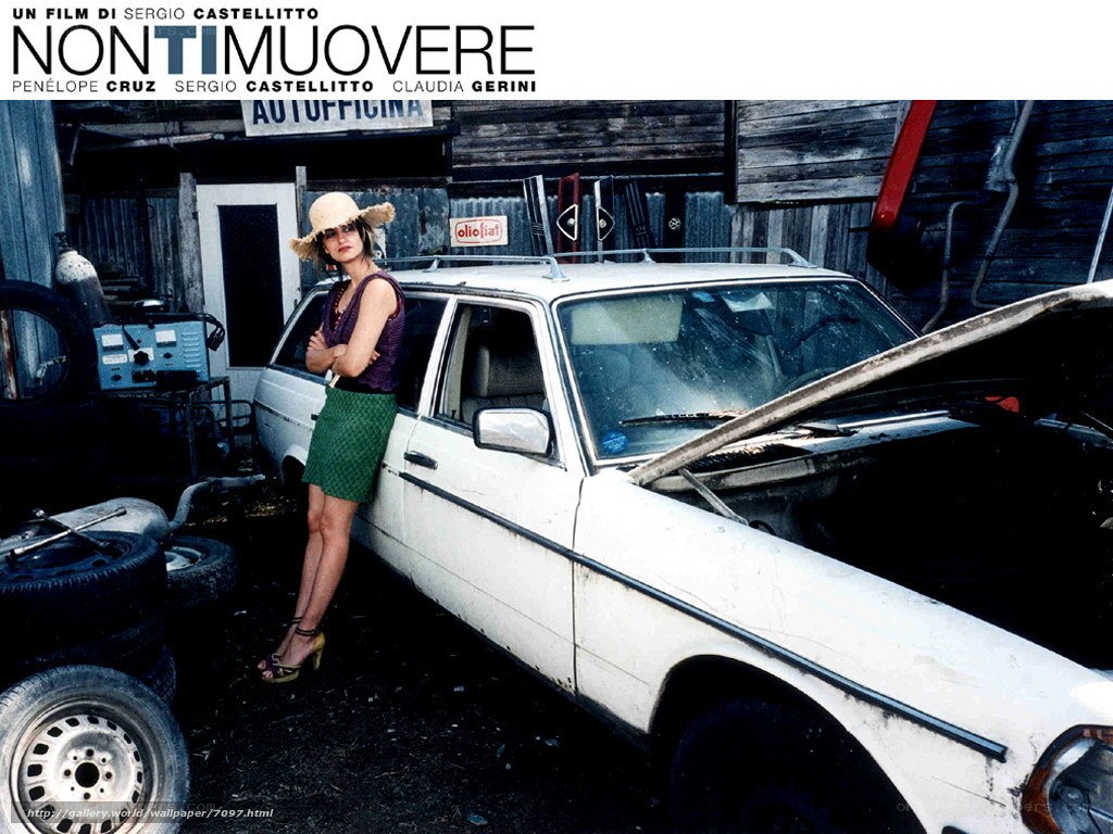 Woman by a car in a garage