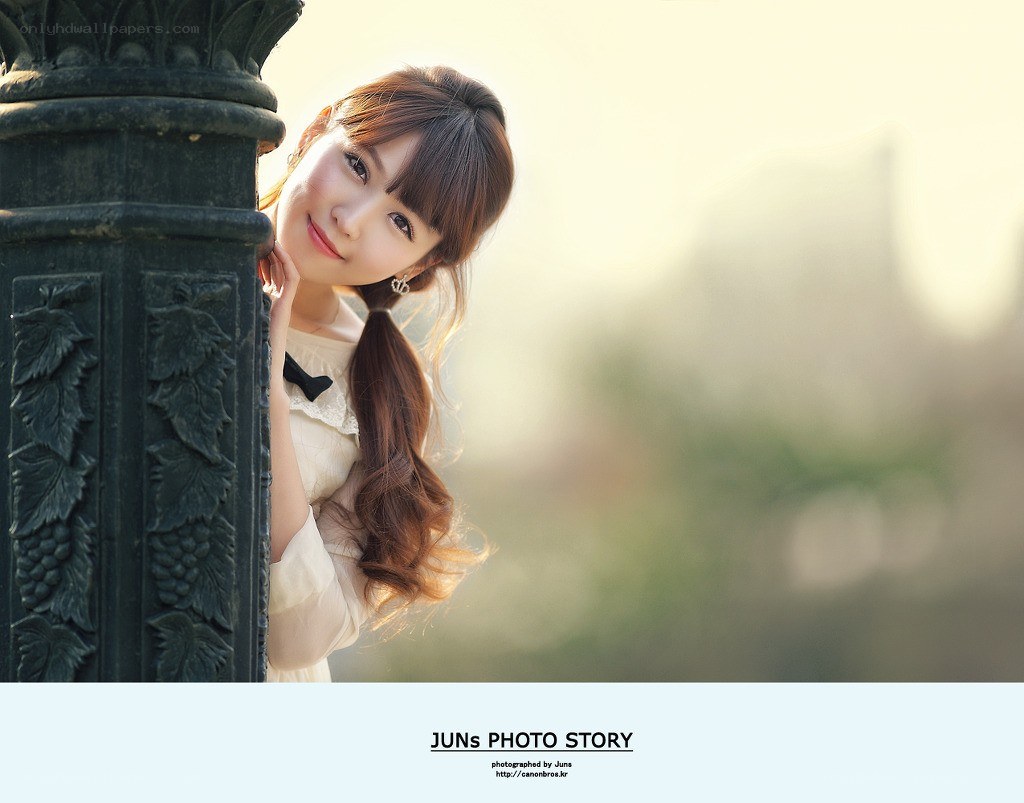 woman by a decorative post