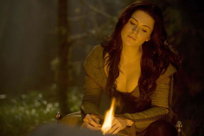 woman by a fire at night