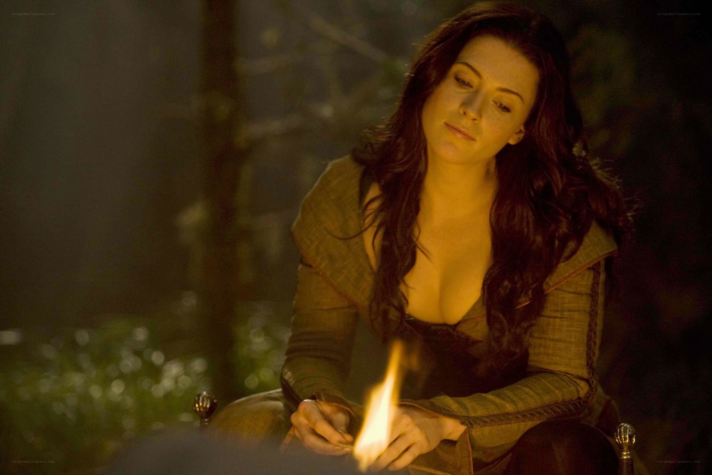 woman by a fire at night