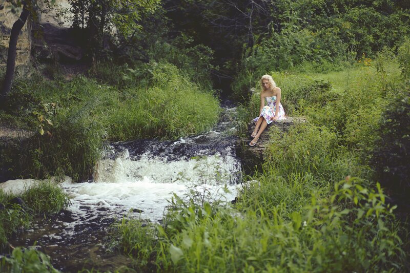 Woman by a forest stream