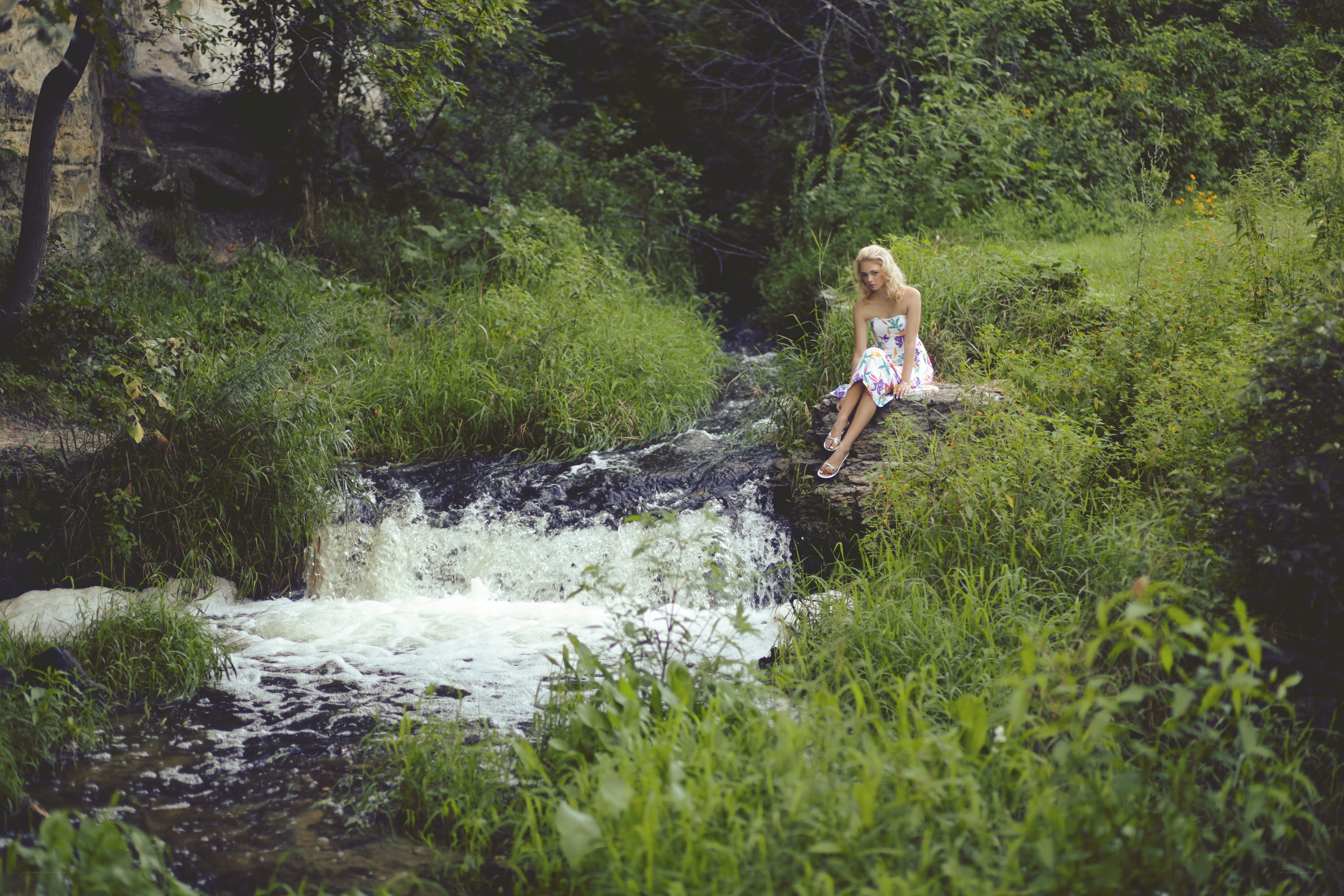 Woman by a forest stream