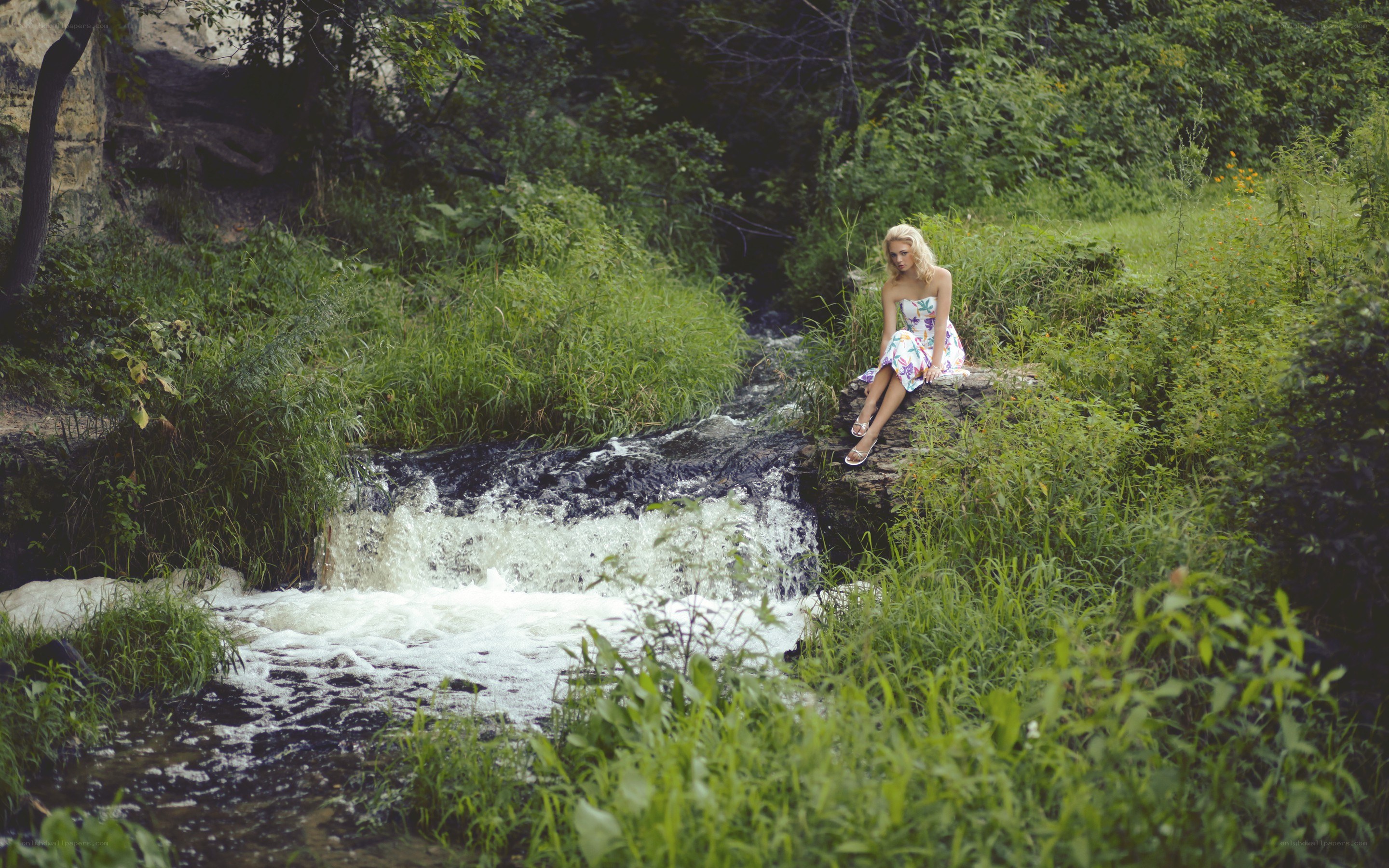 Woman by a forest stream