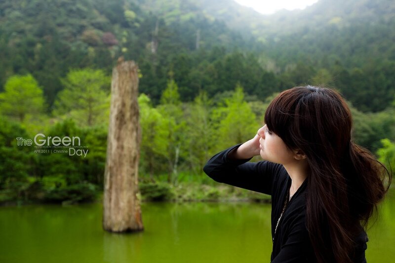 Woman by a green lake