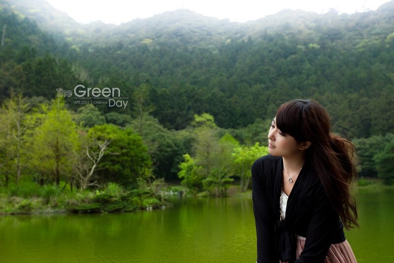 Woman by a green lake