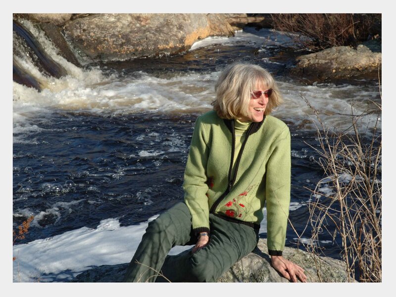 Woman by a river waterfall