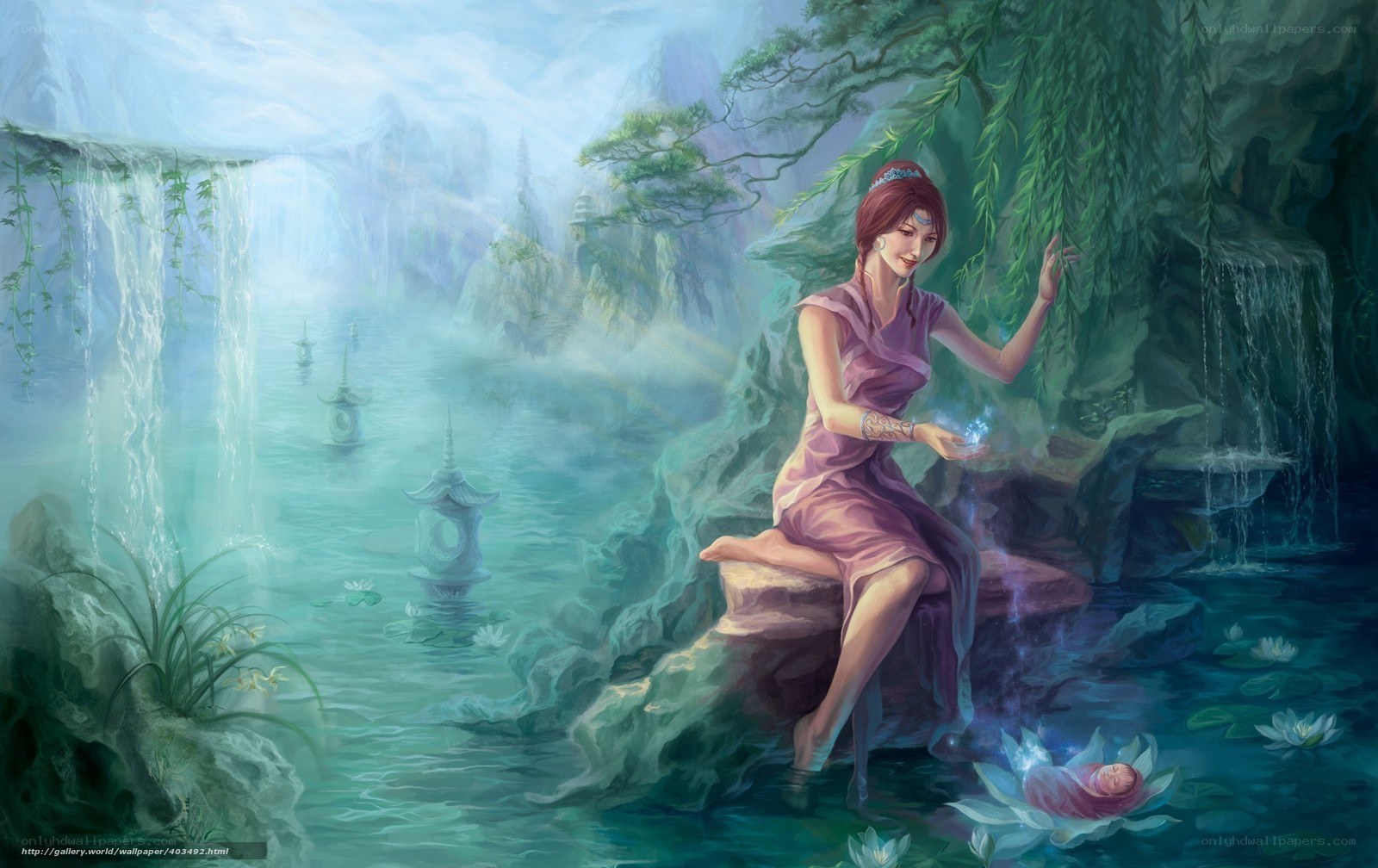 Woman by a waterfall with a baby