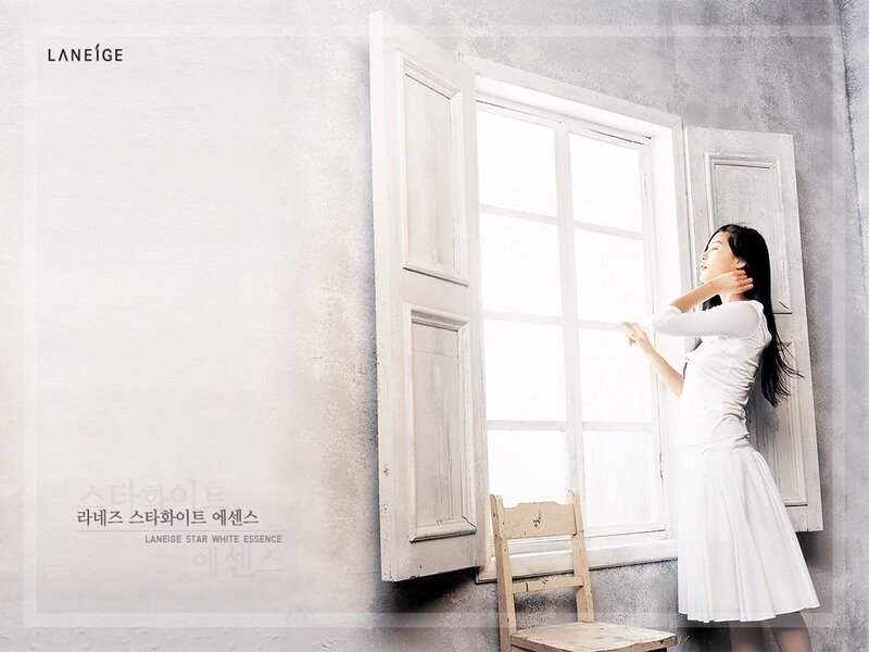 Woman by a window in white dress
