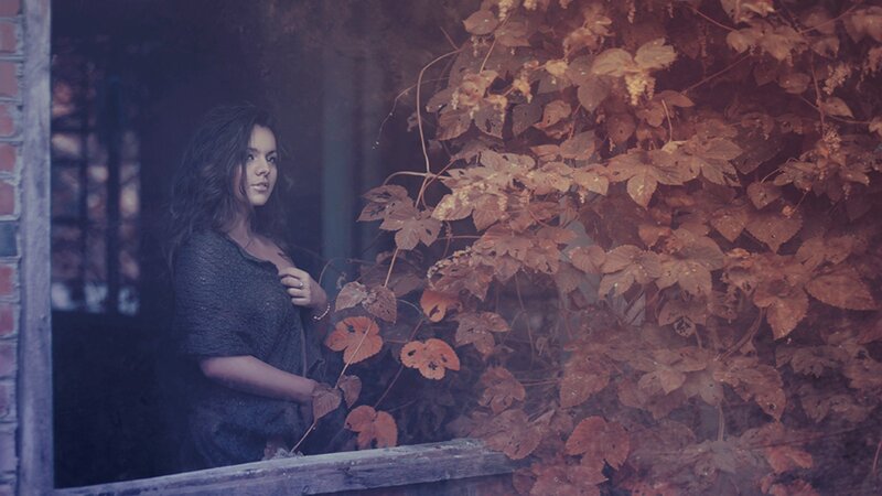woman by autumn leaves