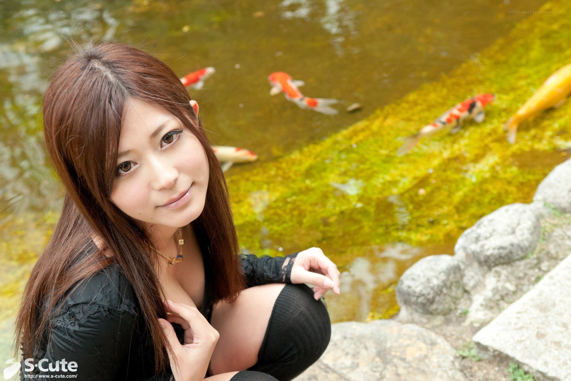 Woman by koi pond