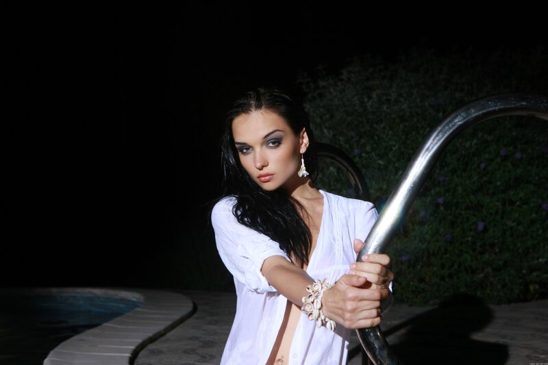 woman by pool at night