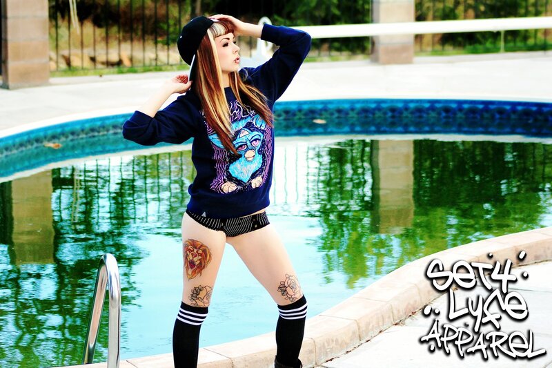 woman by pool in graphic sweatshirt