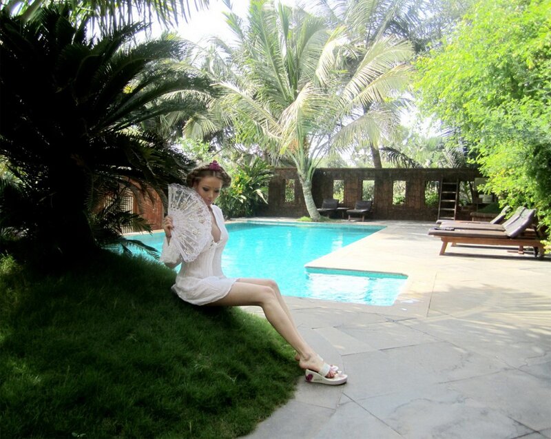 Woman by poolside with fan