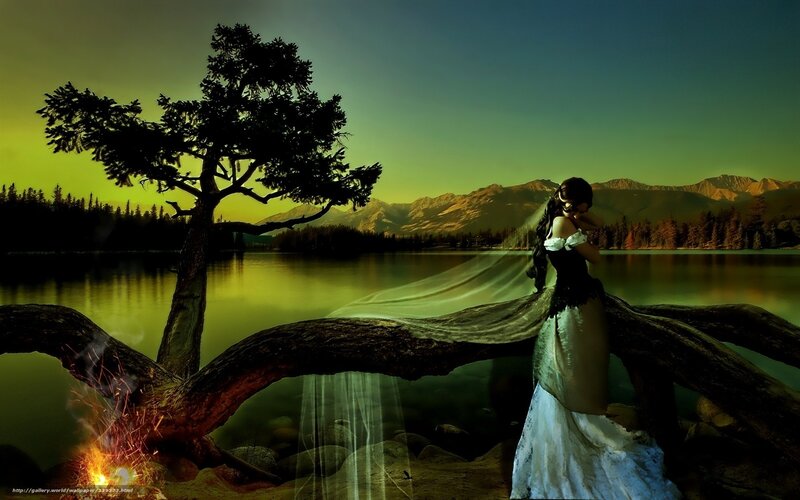 Woman by the lake at sunset