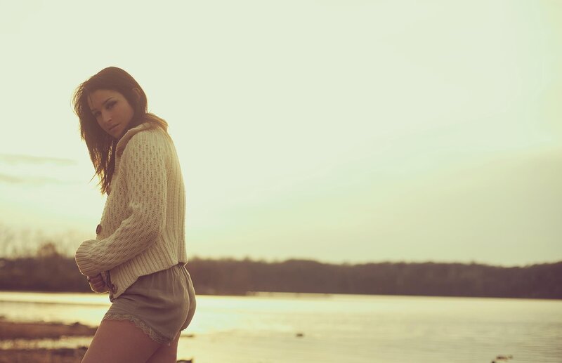 woman by the lake at sunset